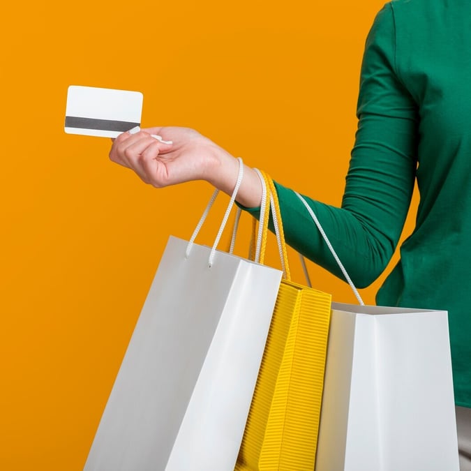 woman-holding-credit-card-many-shopping-bags_23-2148673313